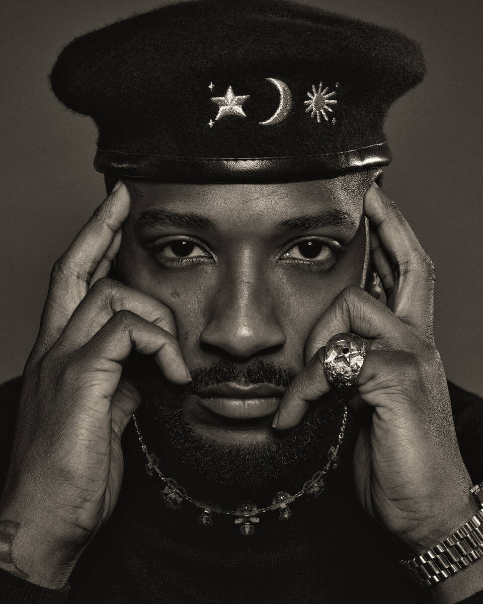 19Keys — hands at temples, sepia editorial portrait
